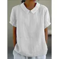 Detail view of a white cotton linen shirt with a Peter Pan collar and ruffled sleeve cuffs. - S / Tops / White