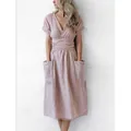 Close-up detail of a dusty pink cotton linen midi dress with V-neck and large front pockets - S / Top And Bottom / Lotus Pink