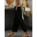 Side view of woman wearing black cotton linen cropped pants in a rustic outdoor setting - S / Bottoms / Black