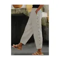 Side view of striped casual trousers with decorative buttons and elastic waist - Apricot
