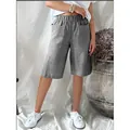 Detail of vintage grey striped high-waisted loose casual shorts for women shown on model - S / Bottoms / Black