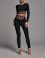 Detailed view of black long-sleeve two-piece set with sheer mesh cut-out panels - XS / Top And Bottom / Black