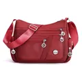 Multi-pocket waterproof nylon crossbody bag for women in dark red finish - Red