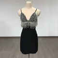 Detailed view of the sequined bodice and crystal fringe on a black bandage mini dress - L / Bottoms / Black