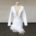 Detail of white bandage dress featuring deep V-neck with rhinestone trim and feather hem - S / Top And Bottom / White (With Waist Rhinestone Chain)
