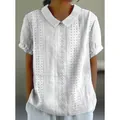 Close-up of white short-sleeved blouse with eyelet embroidery and Peter Pan collar - S / Tops / White