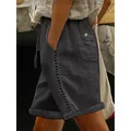 Side view of women's casual black shorts with lace hollow-out stitching detail. - Dark Gray