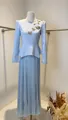 Detail view of light blue pleated long sleeve dress with floral beadwork and peplum waist - XS / Top And Bottom / Blue