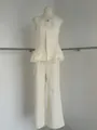 Detailed view of cream sleeveless top with lace hem and matching wide-leg trousers - XS / Top And Bottom / Apricot
