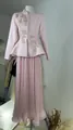 Detail of leaf embroidery on pink peplum blazer paired with a long pleated skirt - Pink