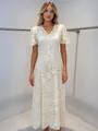 Full view of elegant white lace dress with fringe details on mannequin. - XS / Top And Bottom / Apricot