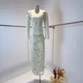 Detailed view of white long-sleeve dress featuring heavy floral lace embroidery. - XS / Top And Bottom / Apricot