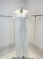 Detailed view of white heavy lace dress with V-neck and delicate floral embroidery - XS / Top And Bottom / White