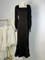Elegant black long-sleeved maxi dress with 3D flower details on a mannequin display. - XS / Top And Bottom / Black