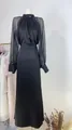 Detailed view of elegant French black evening gown featuring sheer sleeves and beaded collar - XS / Top And Bottom / Black