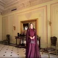Detailed view of an elegant plum purple evening gown featuring dramatic cape sleeves - XS / Top And Bottom / Burgundy