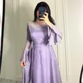 Detail view of a lavender purple maxi dress featuring pearl chain neckline and flared sleeves - XS / Top And Bottom / Lavender