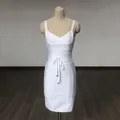 Elegant white V-neck bandage mini dress with waist tie displayed on mannequin stand - S / White Bodycon Style