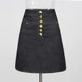 Close-up detail of dark denim A-line skirt featuring six gold artistic buttons and stitching - S / Bottoms / Dark Blue