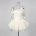 Detail of white off-the-shoulder mesh dress with boned corset and tiered tulle skirt. - S / Tops / Apricot