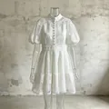 Detailed view of an elegant white puff sleeve dress with intricate lace embroidery - S / White