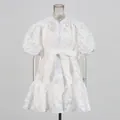 Detailed view of white puff sleeve lace dress with hollow jacquard and bow tie waist. - S / Top And Bottom / White
