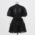 Detailed view of a black puff sleeve hollow-out jacquard mini dress with waist belt - S / Top And Bottom / Black