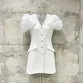 Close-up of elegant white V-neck blazer dress featuring sheer puff sleeves and crystals - S / Top And Bottom / White