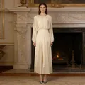 Elegant cream pleated maxi dress with round neck and long sleeves in a classical interior. - S / Yellow