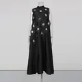 Detailed view of an elegant black sleeveless A-line dress with 3D floral appliques - S / Bottoms / Black