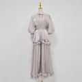 Elegant lilac puff sleeve maxi dress with ruffled hem and waist detail on a mannequin - Purple