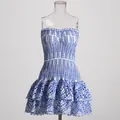 Detail view of blue and white eyelet embroidered mini dress with smocked bodice. - Blue
