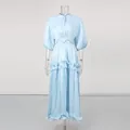 Detail view of the pleated light blue dress with tiered ruffles and puff sleeves - S / Blue