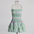 Detailed view of white mini dress with green and purple floral embroidery and tiered ruffles - Printed Green
