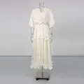 Full view of elegant French style cream dress with puff sleeves and ruffled tiers on mannequin - S / Apricot