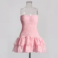 Front view of a pink smocked strapless mini dress with tiered eyelet lace skirt - S / Top And Bottom / Pink