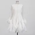 Front view of an elegant white A-line dress with ruffle hem and flared bell sleeves - S / Top And Bottom / White