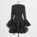 Close-up detail of elegant black dress featuring tiered ruffle hem and flared bell sleeves - S / Top And Bottom / Black
