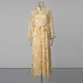Full-length view of a yellow floral maxi dress with lantern sleeves and belted waist. - S / Top And Bottom / Yellow
