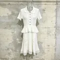 Detailed view of white knit dress with lace embroidery and ruffled waist decoration - S / White