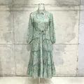 Detailed shot of a pastoral tiered teal maxi dress with shirt collar and lantern sleeves - Green