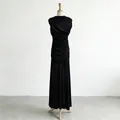 Close-up detail of an elegant ruched sleeveless black maxi dress with draped design - S / Black