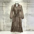 Romantic leopard print midi dress featuring V-neck and lantern sleeves displayed on a mannequin - Leopard Print