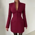 Close-up of wine-red slim-fit blazer dress with stand collar and decorative buttons. - S / Burgundy
