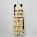 Detailed view of cream tiered ruffle maxi dress featuring elegant black bow shoulder straps - S / Tiered Style / Yellow