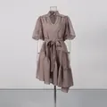 Detail showing the V-neck lace patchwork and puff sleeve of a tea-break style dress. - S / Top And Bottom / Brown
