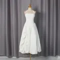 Elegant white halter neck dress with pleated bodice and puffy bubble skirt on mannequin. - S / Top And Bottom / White