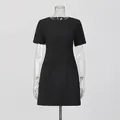 Elegante abito corto nero a maniche corte con girocollo su un manichino trasparente - Taglia S / Top E Pantaloni / Nero