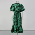 Front view of green floral maxi dress with puff sleeves and belted waist on mannequin - S / Top And Bottom / Green