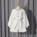 Close-up view of elegant white jacket with rhinestone collar on a gold mannequin - M / Tops / White